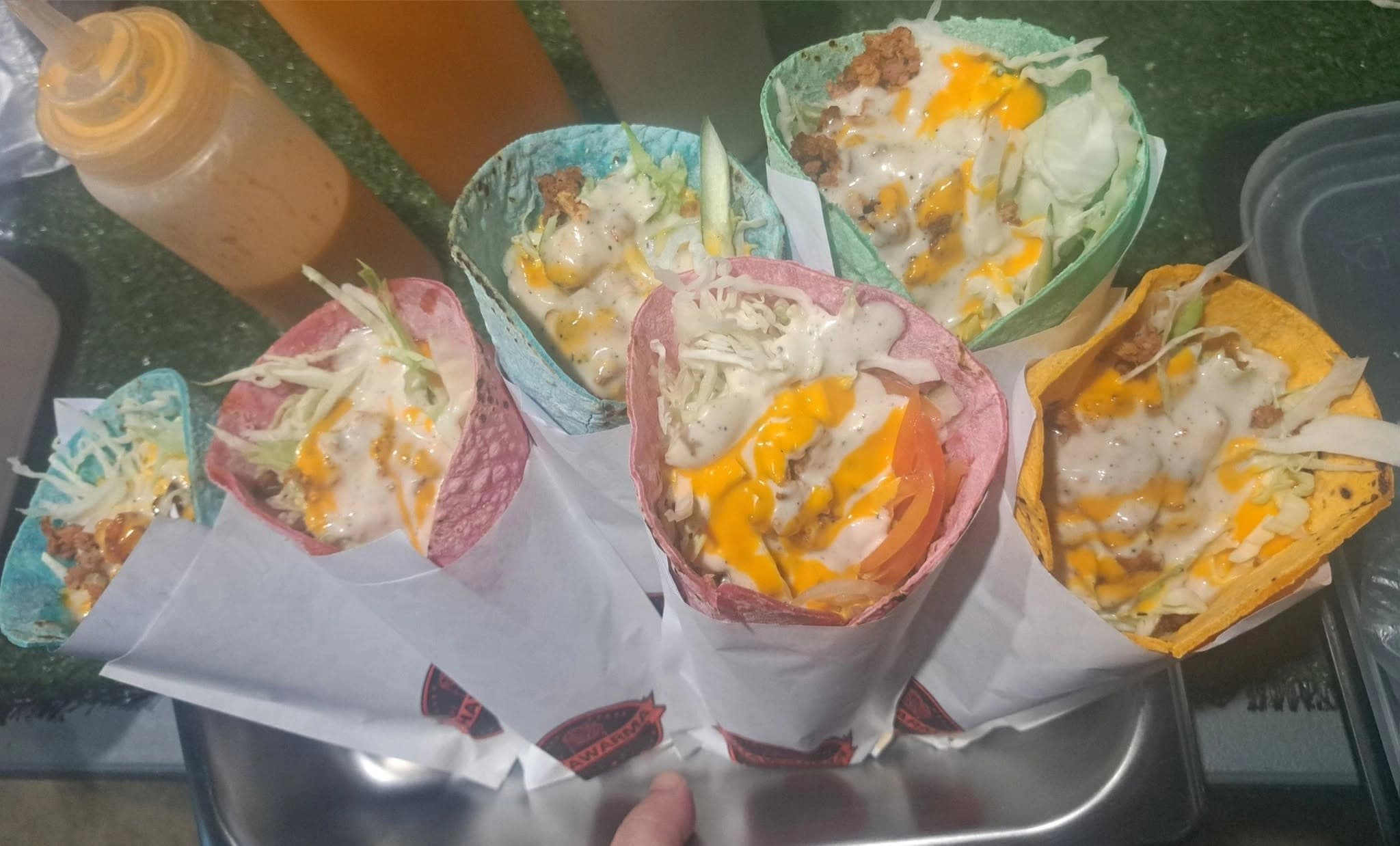 assorted shawarma wraps handheld
